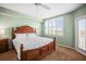 Bedroom with a decorative wooden bed frame, shuttered windows, and a ceiling fan for a bright and airy feel at 6450 Shoreline Dr Dr # 9202, St Petersburg, FL 33708