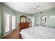 A well-lit bedroom with a decorative dresser and balcony access, leading to dining and bath areas at 6450 Shoreline Dr Dr # 9202, St Petersburg, FL 33708