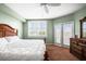 Bright bedroom featuring a white ceiling fan, shuttered windows, and a comfortable bed with white bedding at 6450 Shoreline Dr Dr # 9202, St Petersburg, FL 33708