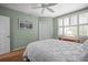 Cozy bedroom featuring shuttered windows, a ceiling fan, and ample natural light for a serene atmosphere at 6450 Shoreline Dr Dr # 9202, St Petersburg, FL 33708