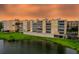 Condo complex features a manicured lawn, lake view and exterior building lighting at 6450 Shoreline Dr Dr # 9202, St Petersburg, FL 33708
