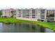 Beautiful condo building with screened balconies overlooking a pond and landscaped grounds at 6450 Shoreline Dr Dr # 9202, St Petersburg, FL 33708