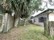 Backyard featuring a privacy fence, mature trees, and greenery at 9578 121St St, Seminole, FL 33772