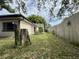 Backyard with mature trees, grassy areas, and privacy fence at 9578 121St St, Seminole, FL 33772