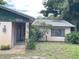 Home's entrance featuring a well-lit doorway and decorative landscaping at 9578 121St St, Seminole, FL 33772