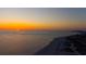 Aerial view of the sun setting over ocean, capturing picturesque views of the coastline at 11000 Gulf Blvd # 1002, Treasure Island, FL 33706