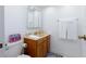 Functional bathroom featuring a wood vanity, toilet, mirror, and towel rack at 11000 Gulf Blvd # 1002, Treasure Island, FL 33706
