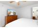 Bright bedroom with a large dresser, television, and a walk-in closet at 11000 Gulf Blvd # 1002, Treasure Island, FL 33706