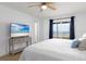 Bright bedroom has wood-look flooring, balcony access with an ocean view, and a ceiling fan at 11000 Gulf Blvd # 1002, Treasure Island, FL 33706