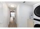Hallway with laundry machines leading to a bedroom with a view at 11000 Gulf Blvd # 1002, Treasure Island, FL 33706