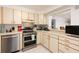 Well-lit kitchen features stainless steel appliances and ample countertop space with an open view to the dining area at 11000 Gulf Blvd # 1002, Treasure Island, FL 33706