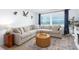 Inviting living room featuring a comfortable sectional, beach view, and stylish decor at 11000 Gulf Blvd # 1002, Treasure Island, FL 33706