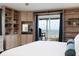 Bright main bedroom with built-in shelving, balcony access, and an ocean view at 11000 Gulf Blvd # 1002, Treasure Island, FL 33706
