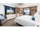 Bright main bedroom includes built-in shelving, a mounted television, and a beautiful ocean view at 11000 Gulf Blvd # 1002, Treasure Island, FL 33706