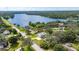 Aerial view showcasing the property's location on a lake, surrounded by lush greenery and upscale homes at 11301 Donneymoor Dr, Riverview, FL 33569
