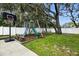 Backyard features a playset area including slide and swing set and basketball court for Gathering fun at 11301 Donneymoor Dr, Riverview, FL 33569