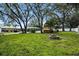 Large backyard with fire pit, screened pool, shed, and ample green space for recreation at 11301 Donneymoor Dr, Riverview, FL 33569