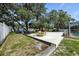 Landscaped backyard featuring a play area and seating near the screened-in pool, great for Gathering enjoyment at 11301 Donneymoor Dr, Riverview, FL 33569