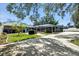 Backyard featuring a concrete patio with a grill and an enclosed pool for relaxation and entertainment at 11301 Donneymoor Dr, Riverview, FL 33569