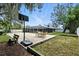 Inviting backyard with screened pool, basketball court, and patio seating for outdoor enjoyment at 11301 Donneymoor Dr, Riverview, FL 33569