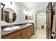 Bathroom boasts double sinks, wooden cabinets, and granite countertops at 11301 Donneymoor Dr, Riverview, FL 33569