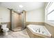 Bathroom with tiled shower and a luxurious soaking tub at 11301 Donneymoor Dr, Riverview, FL 33569