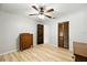 Bedroom includes wood-look floors, ceiling fan, dresser, and closet at 11301 Donneymoor Dr, Riverview, FL 33569