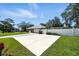 Exterior view of a brick home with a long driveway leading to a garage and a fenced yard at 11301 Donneymoor Dr, Riverview, FL 33569