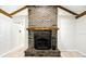 Living room brick fireplace with mantel and ornate wrought iron fire screen at 11301 Donneymoor Dr, Riverview, FL 33569