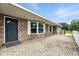 Close-up view of a brick home featuring a front door with decorative window and paved patio at 11301 Donneymoor Dr, Riverview, FL 33569