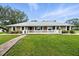 Charming brick home with large front yard, white fence, and brick pathway at 11301 Donneymoor Dr, Riverview, FL 33569