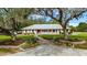 Beautiful brick home with manicured landscaping, brick walkway and a charming white picket fence at 11301 Donneymoor Dr, Riverview, FL 33569