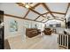 Spacious living room with vaulted ceilings, wood beams, and view of pool area at 11301 Donneymoor Dr, Riverview, FL 33569