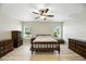 Neutral main bedroom features wood-look flooring and dual windows at 11301 Donneymoor Dr, Riverview, FL 33569