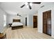 Bright main bedroom features luxury vinyl flooring, ceiling fans, and natural light from windows at 11301 Donneymoor Dr, Riverview, FL 33569