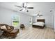 Bright main bedroom features luxury vinyl flooring, ceiling fans, and natural light from windows at 11301 Donneymoor Dr, Riverview, FL 33569
