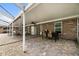 Covered outdoor patio featuring comfortable seating and dining areas, perfect for entertaining and relaxation at 11301 Donneymoor Dr, Riverview, FL 33569
