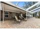 Spacious covered patio featuring comfortable seating and brick flooring, ideal for relaxing or entertaining guests at 11301 Donneymoor Dr, Riverview, FL 33569
