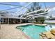 A stunning in-ground pool with a unique rock waterfall feature and a screened enclosure for year-round enjoyment at 11301 Donneymoor Dr, Riverview, FL 33569