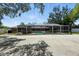 Spacious backyard featuring a screened pool area, a concrete patio, and an outdoor grill at 11301 Donneymoor Dr, Riverview, FL 33569