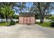 Backyard shed is clean, spacious, and ready for storage with mature landscaping around the yard at 11301 Donneymoor Dr, Riverview, FL 33569