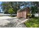 Backyard shed providing extra storage space, next to a play area and basketball court at 11301 Donneymoor Dr, Riverview, FL 33569