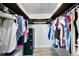 Spacious walk-in closet with wood shelving and plenty of room for organization and clothing storage at 11301 Donneymoor Dr, Riverview, FL 33569