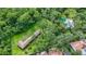 Expansive aerial view of property, highlighting its private wooded acreage with pool and outbuilding at 11503 Robles Del Rio Pl, Temple Terrace, FL 33617