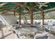 Outdoor cabana with ample seating, ceiling fans, and views of the community pool at 11503 Robles Del Rio Pl, Temple Terrace, FL 33617