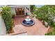 Aerial view of brick-paved courtyard with a central fountain, surrounded by lush greenery and architectural details at 11503 Robles Del Rio Pl, Temple Terrace, FL 33617