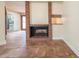 Living room fireplace with brick surround, tile flooring, and an open layout leading to the kitchen at 11503 Robles Del Rio Pl, Temple Terrace, FL 33617