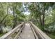 Fishing pier overlooking a scenic pond with mature trees at 11503 Robles Del Rio Pl, Temple Terrace, FL 33617