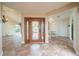 Welcoming foyer with tile flooring, chandelier, and a decorative wood front door with iron accents at 11503 Robles Del Rio Pl, Temple Terrace, FL 33617
