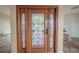 Elegant wood front door featuring decorative glass panels and side lights at 11503 Robles Del Rio Pl, Temple Terrace, FL 33617